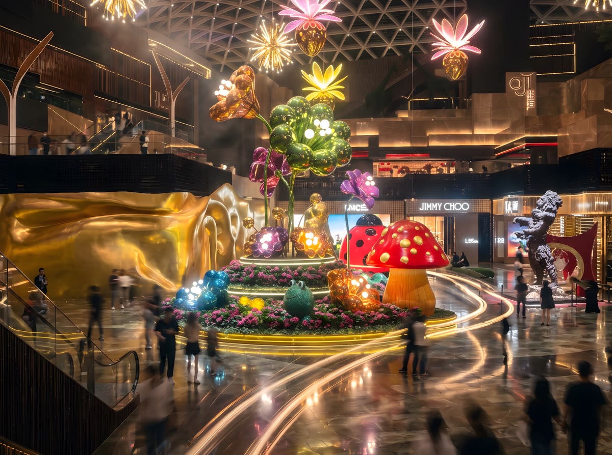 Giant chrome flower sculptures glowing under a lattice dome